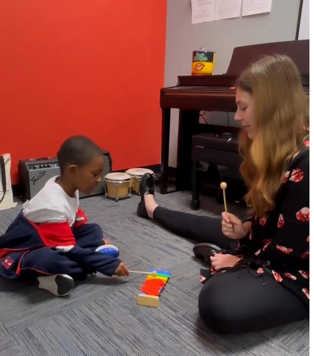 Young student playing xylophone during CSM Music Discovery lesson
