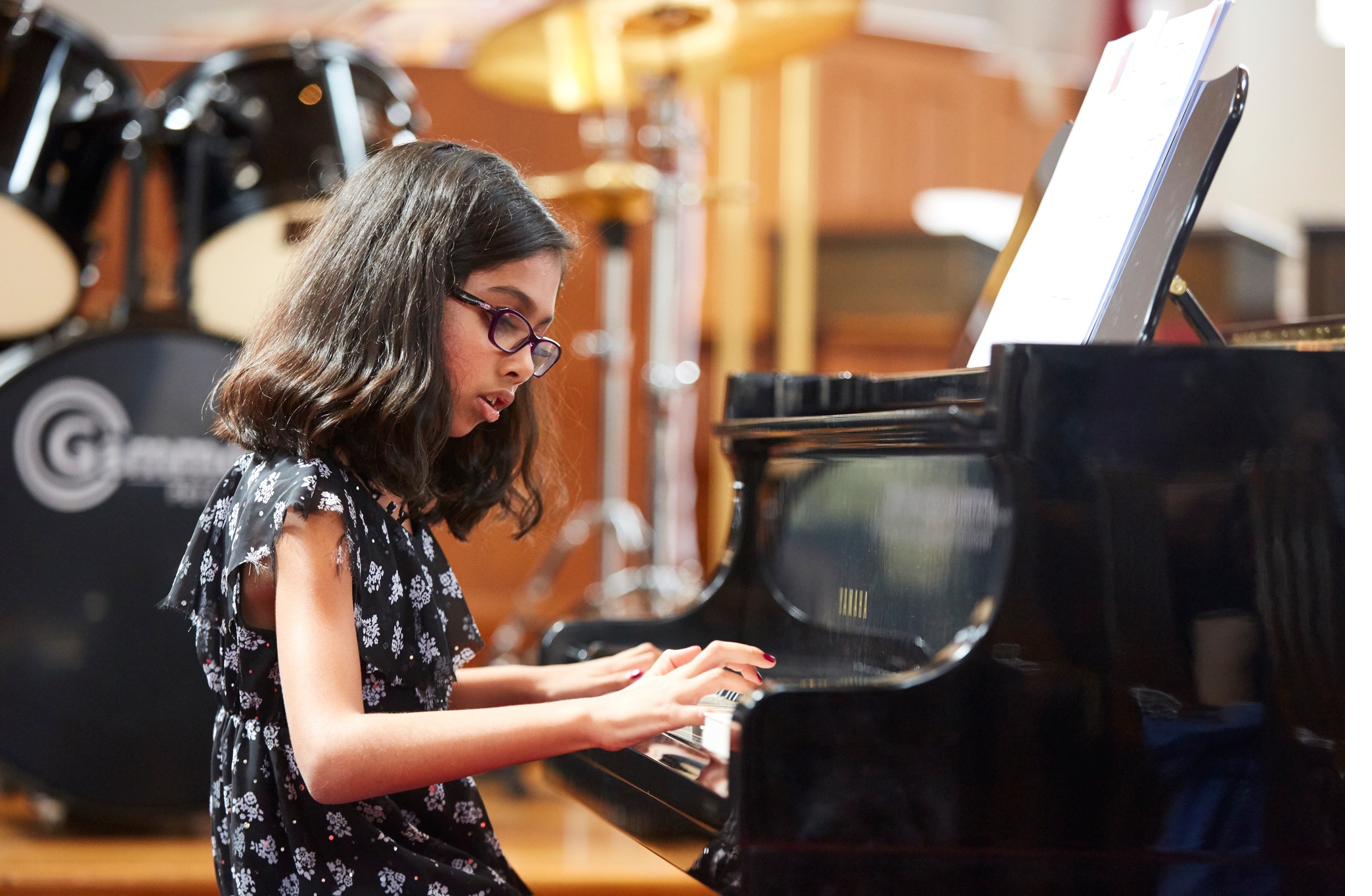 Young student performing at a Cincinnati School of Music piano recital